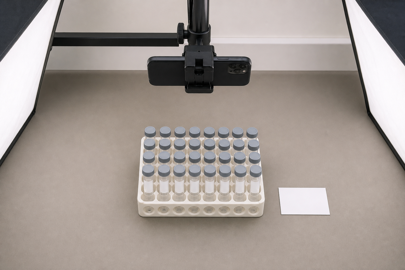 Overhead phone photo setup for a vial rack with even lighting and a reference card